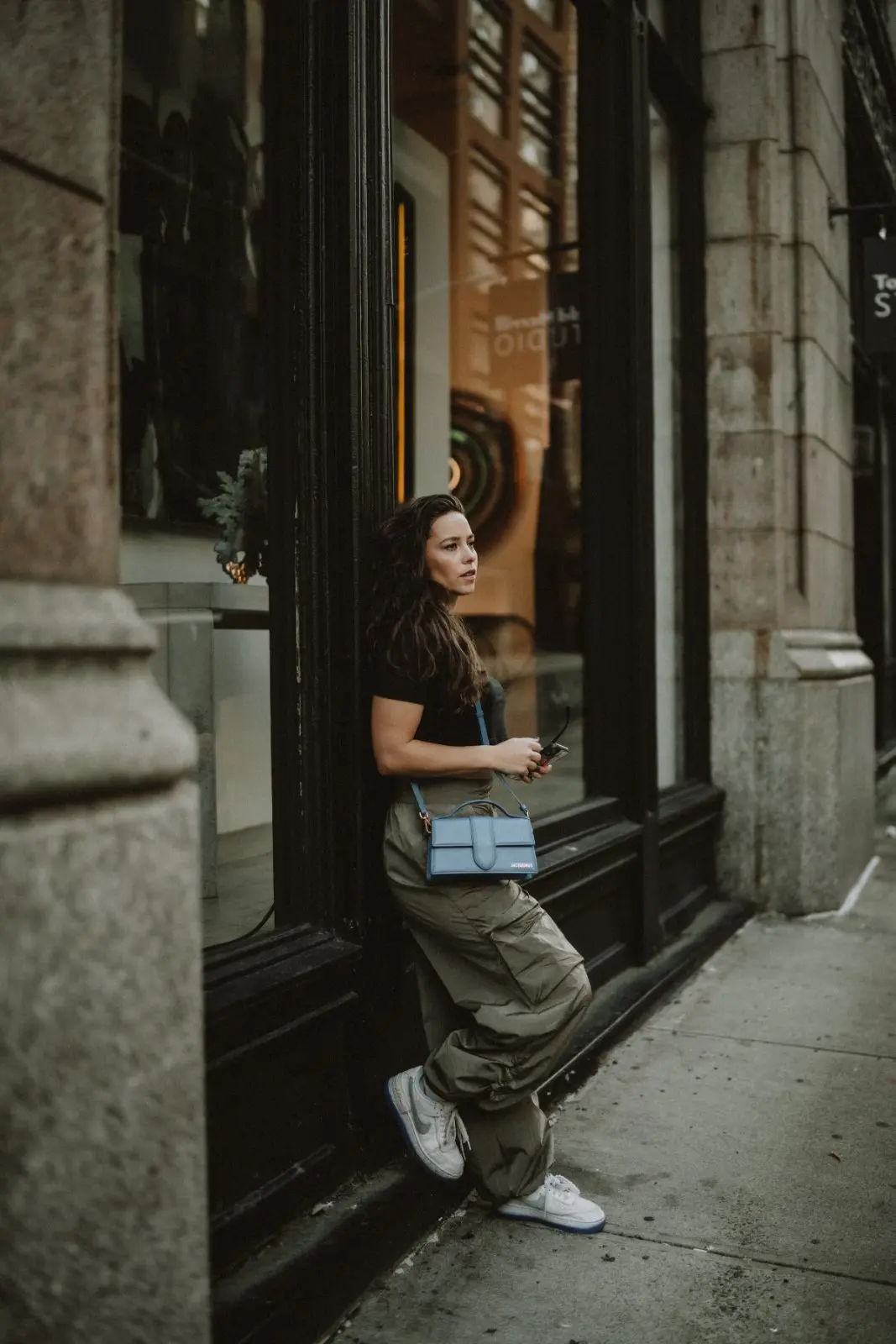 Rachelle standing in a doorway on a New York street