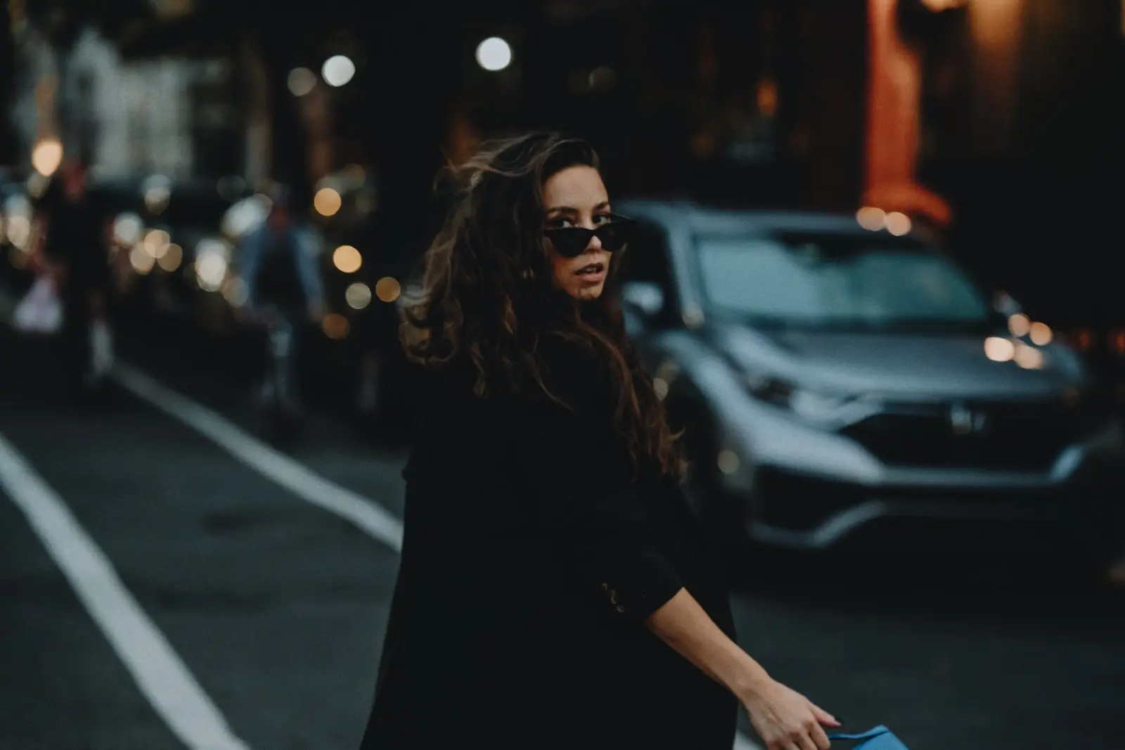 Rachelle in sunglasses on a New York street at dusk